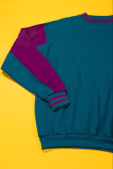 Blue and purple sweater on a yellow background