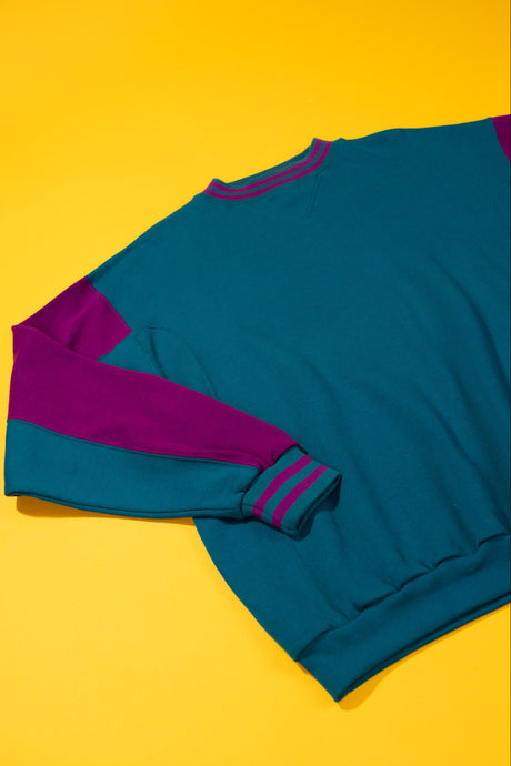 vintage teal and purple crewneck on a yellow background